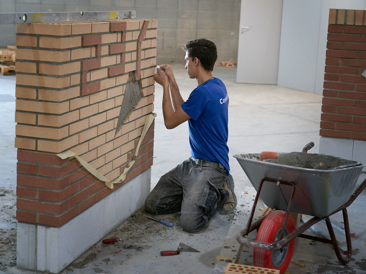 A Competitor builds a brick wall during the WorldSkills Italy nationals in Bolzano, South Tyrol.
