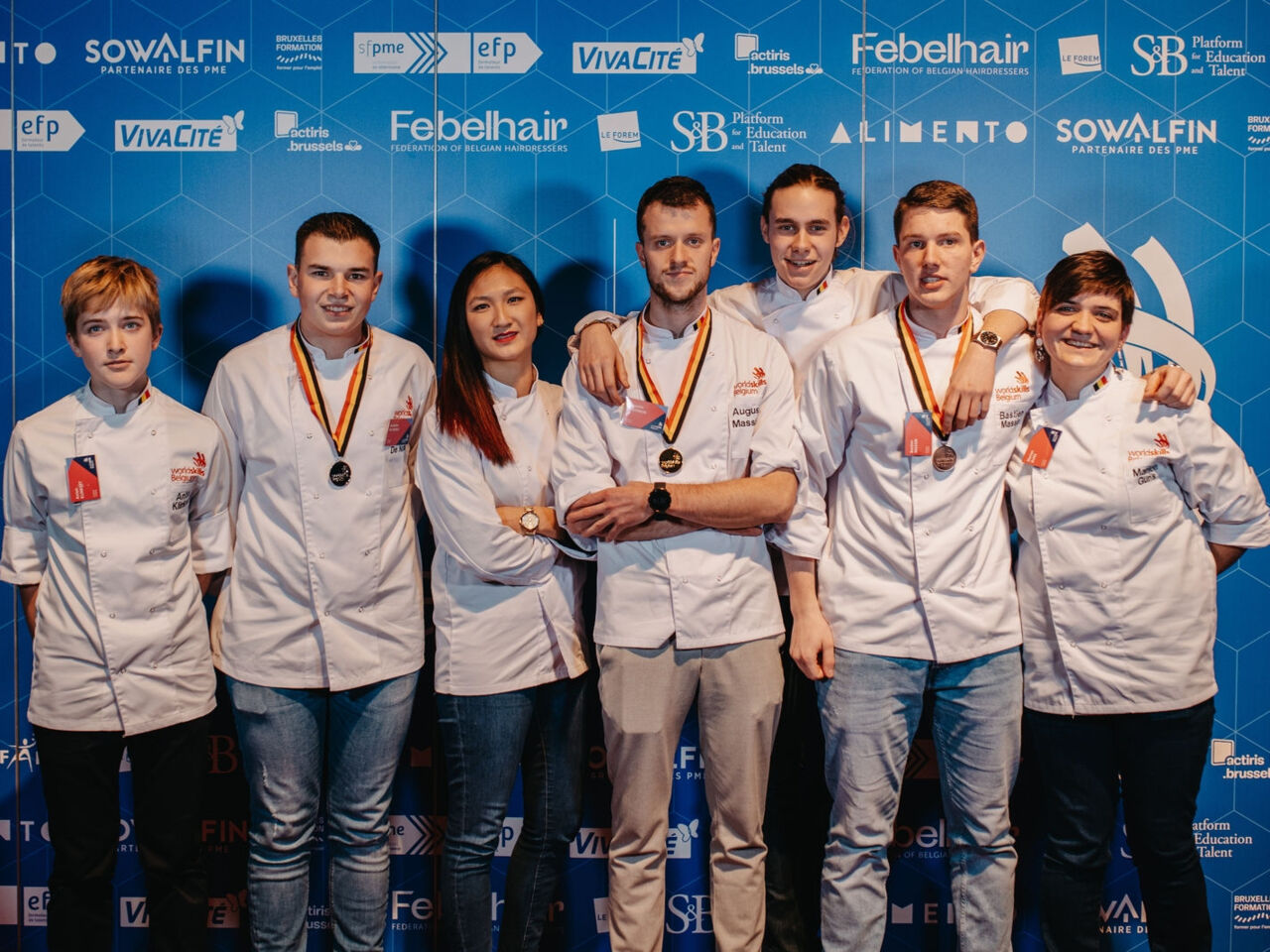 Seven Competitors from the WorldSkills Belgium team pose with medals.
